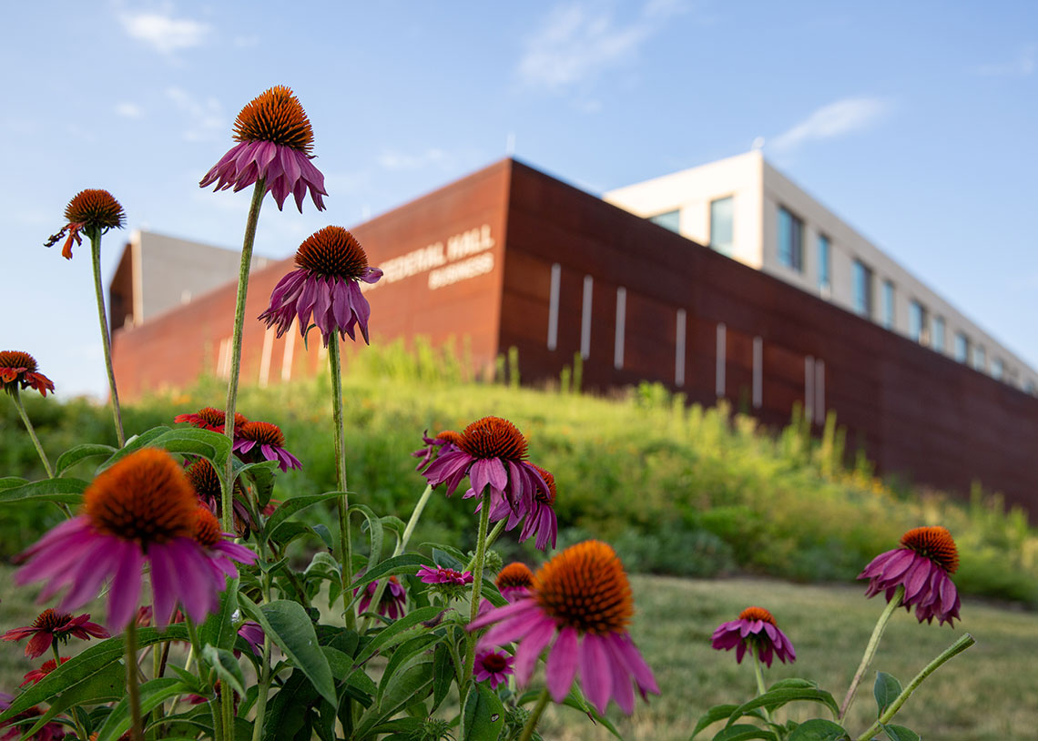 Flowers in focus in front of Capital Federal Hall