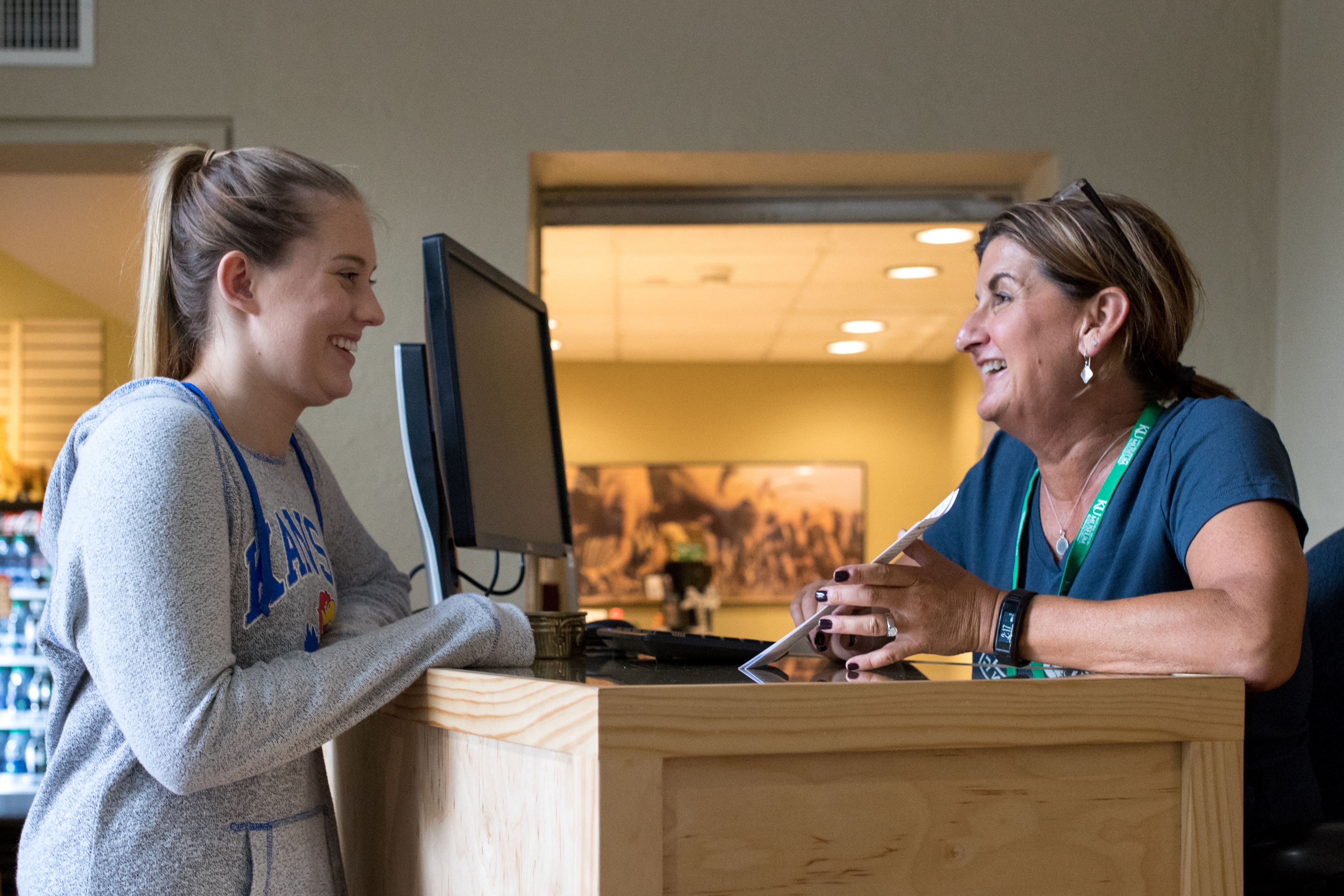 two women talking at help desk